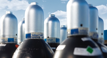 The image shows gas cylinders filled with nitrogen. This is a further version (with cloudy sky) of the original image ID 59543.